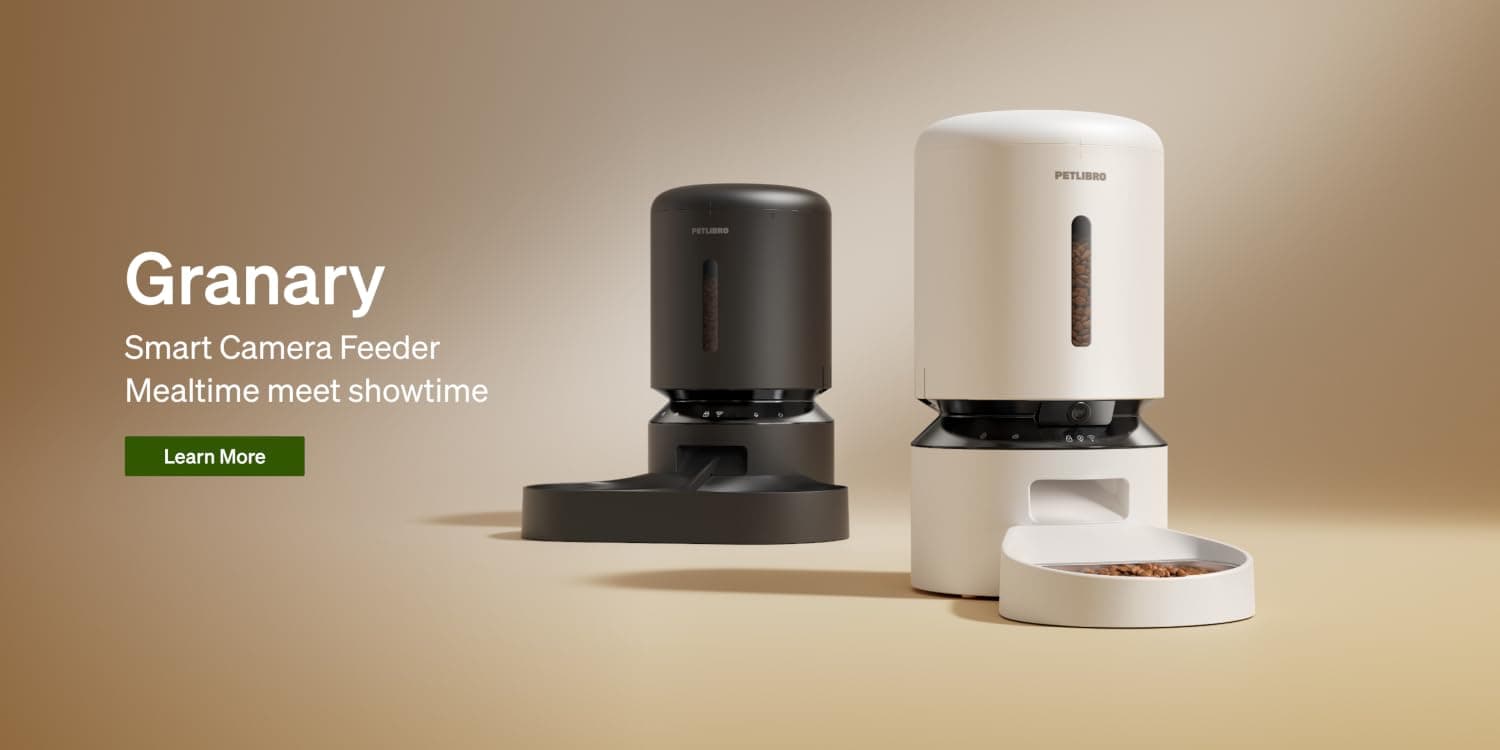 Dog and cat sitting beside a PETLIBRO smart feeder
